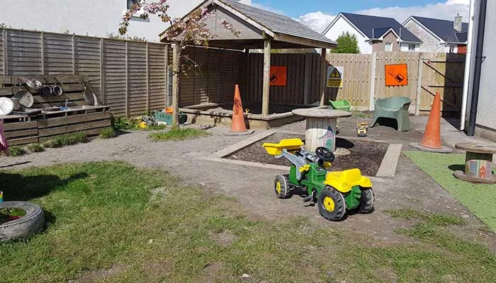 The outdoor courtyard with a ride-on toy and play shed
