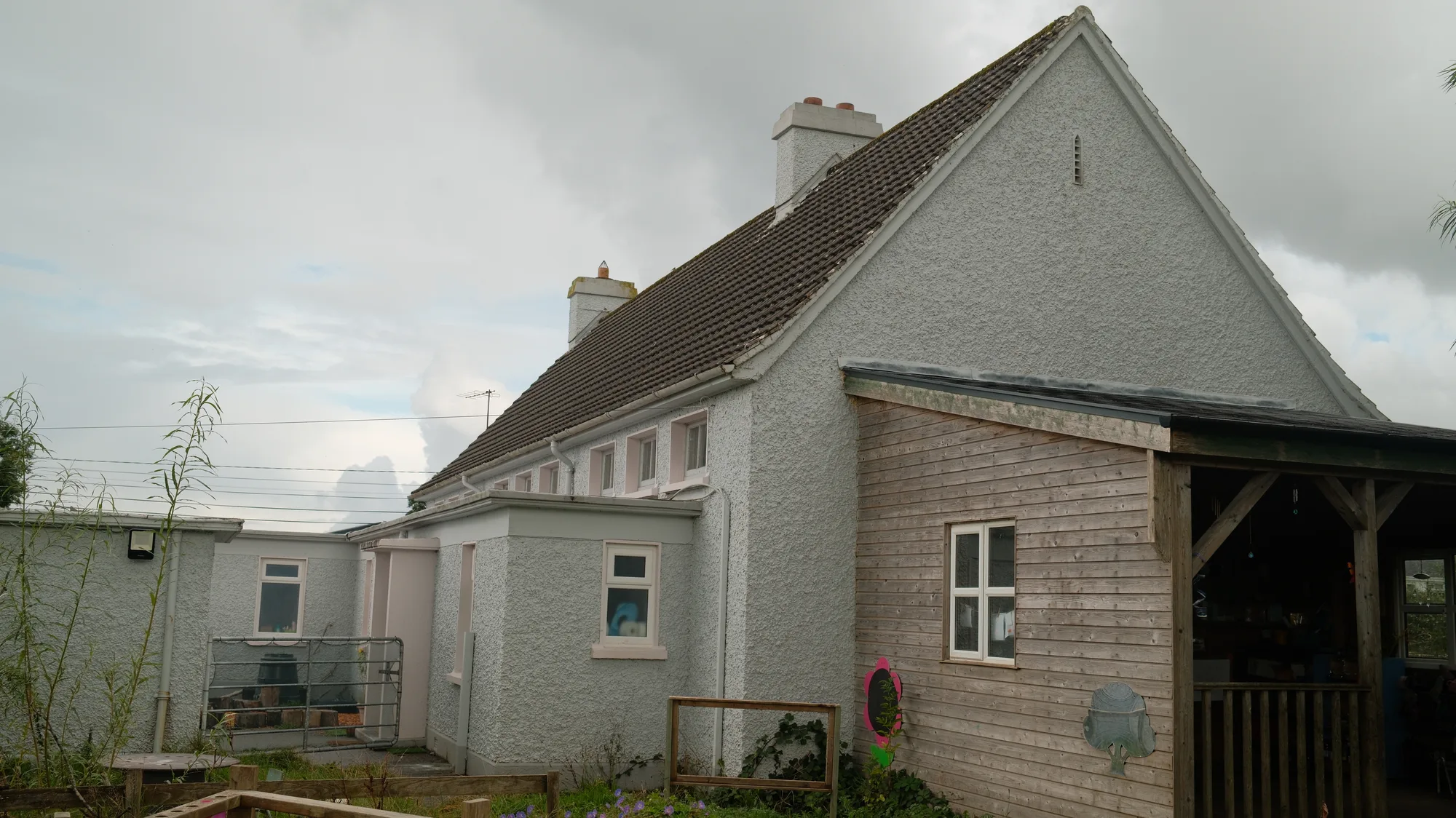 The covered entrance beside the white building