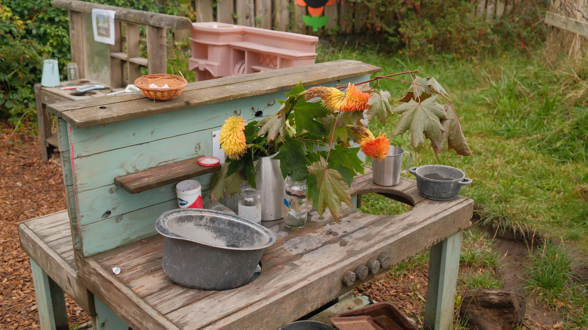 Pots and flowers on the mud kitchen bench
