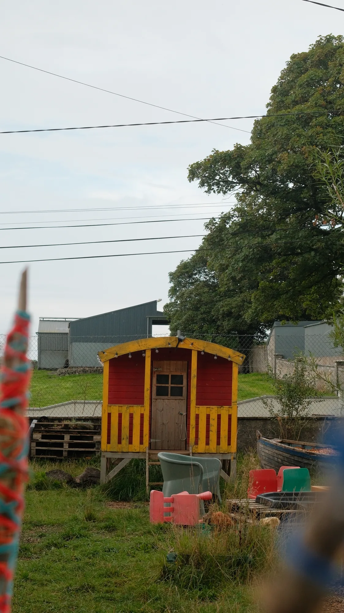 The playhouse and climbing frame seen through the trees