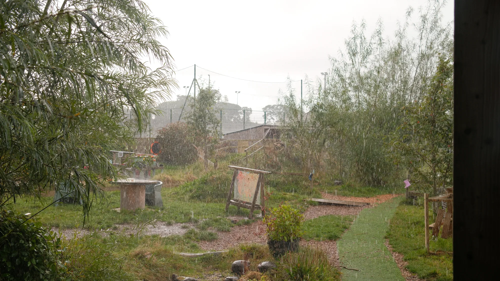 Rain falling across the garden and outdoor seating